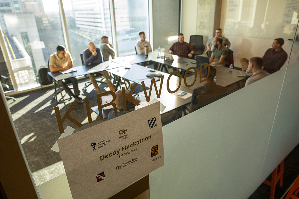 Participants at the Marne Innovation Workshop brainstorming solutions at a table. (Photo Credit: Sean McNeil)