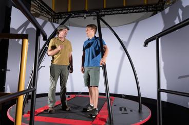 Greg Sawicki and Pawel Kołyski in the Huma PoWeR Lab with a project that measures stability in treadmill walking.