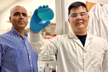 Ankur Singh, left, and Zhonghao (Eric) Dai in the Immunotherapy and Cell Engineering laboratory at the Georgia Institute of Technology. Dai holds a silicon nanowire wafer manufactured as part of a revolutionary effort to reverse aging in human immune cells.