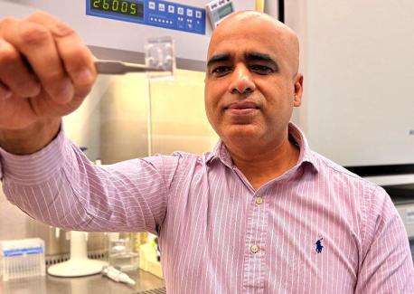 Ankur Singh holds a chip that contains cells used in his research. Singh and fellow researcher Andrés García are working to develop human antibody therapies for hard-to-treat diseases.